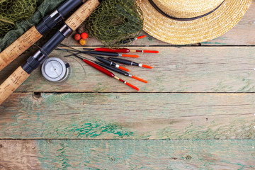 fishing tackle on a wooden table. toned image 