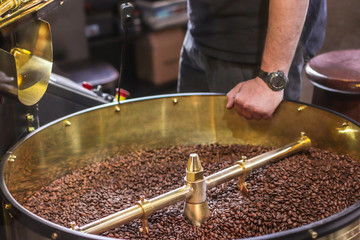 Freshly roasted aromatic coffee beans in a modern coffee roasting machine