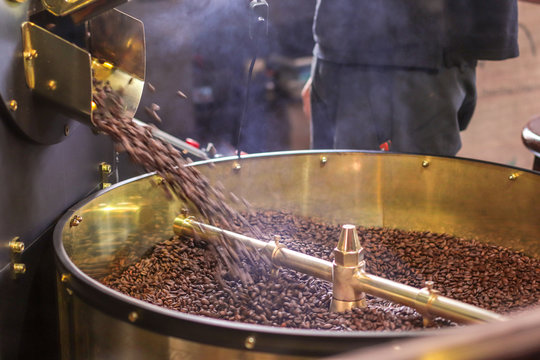 Freshly roasted aromatic coffee beans in a modern coffee roasting machine