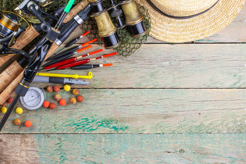 fishing tackle on a wooden table. toned image 