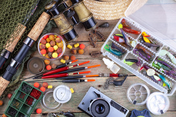 fishing tackle on a wooden table. toned image