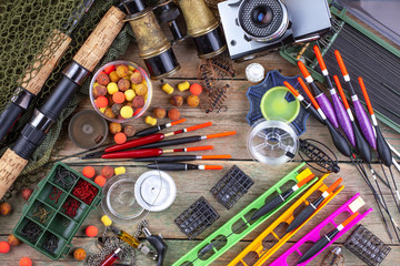 fishing tackle on a wooden table. toned image 