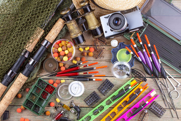 fishing tackle on a wooden table. toned image 