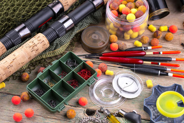 fishing tackle on a wooden table. toned image 