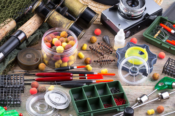 fishing tackle on a wooden table. toned image 