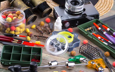 fishing tackle on a wooden table. toned image 