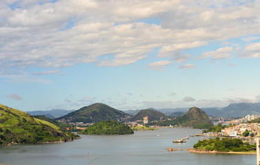 Aerial view of the beautiful city of Vitoria, Espirito Santo, Brazil and its wide bay. The city developed with its high buildings growing on the hills and into the local greenery