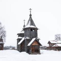 Front view of a russian wooden church in snow