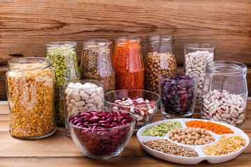 Glass jars with various legumes and grains-beans, rice, lentils, bulgur and grains