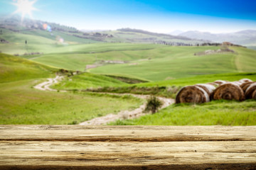 Spring background of table and Tuscany landscape 