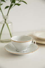 Obraz na płótnie Canvas white cup and saucer on white table