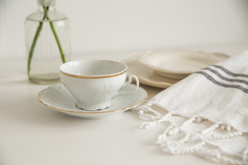Fototapeta na wymiar white cup and saucer on white table