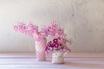 pink hyacinths in vase on white background