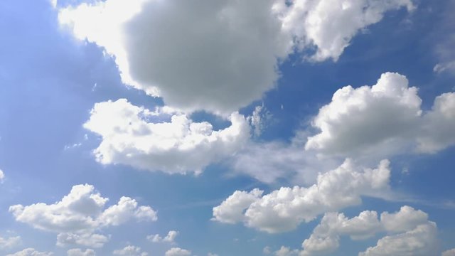 Time lapse of little fluffy clouds disappearing in a blue, bright sunny sky.