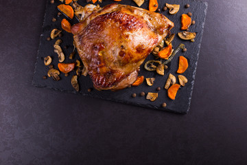 Thigh turkey baked in the oven with spices on black stone background. Healthy food. Thanksgiving...