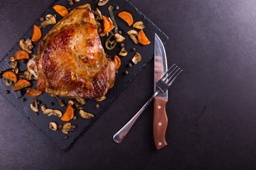 Thigh turkey baked in the oven with spices on black stone background. Healthy food. Thanksgiving...