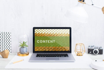 Computer staying on a table & showing the screen. Trendy & vibrant design. Geometry. Innovational digital internet applications & web business solutions. Modern workspace in an office. Development.