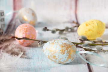 Easter blue eggs in with willow and feathers
