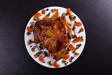 Thigh turkey baked in the oven with spices on black stone background. Healthy food. Thanksgiving dinner.