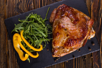 Thigh turkey baked in the oven with spices on black stone board. Healthy food. Thanksgiving dinner.