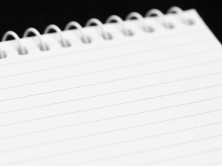 Blank sheet of a notebook on black background