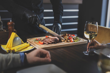 Restaurant chef slicing steak