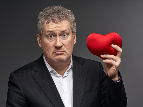 business man with heart puzzled, perplexed, confused, baffled, bewildered, taken aback