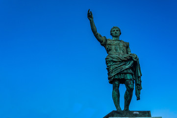 Fototapeta premium Roman emperor bronze statue on blue sky background