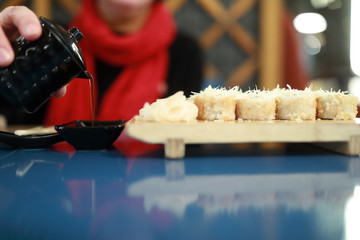Person pours soy sauce