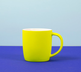 New yellow Cup on solid pastel background.