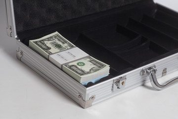 Open suitcase with one million dollars bills with tape