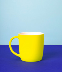New yellow Cup on solid pastel background.