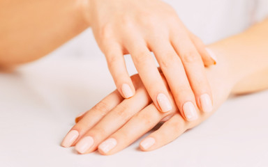 Obraz na płótnie Canvas Female hands with beige manicure.