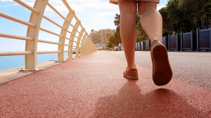 Closeup of lady legs walking along unpolluted pavement, concept of clean city