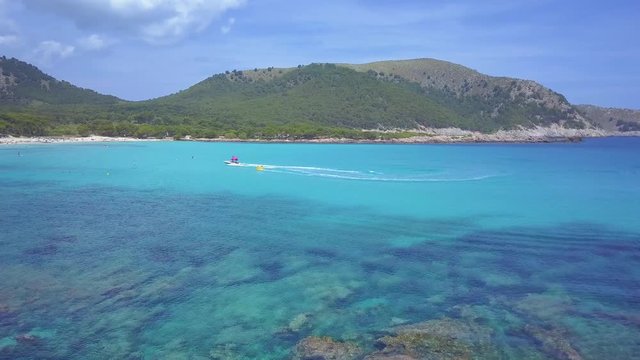 Aerial view of beautiful Mallorca beach, Cala agulla. Flight above clear blue water.