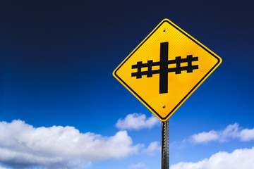 Railroad or railway crossing sign and sky with copy space.