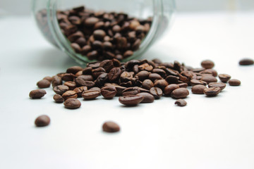 Heap of coffee beans from jar.