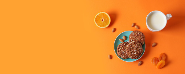Oatmeal cookies with nuts on a plate, cup of milk