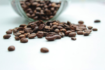 Heap of coffee beans from jar.