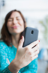 Fototapeta premium woman taking selfie with smartphone