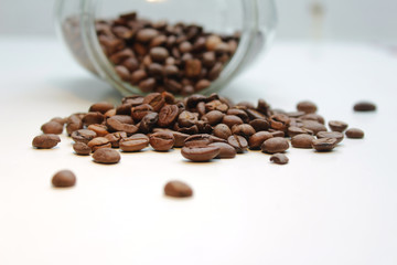 Heap of coffee beans from jar.