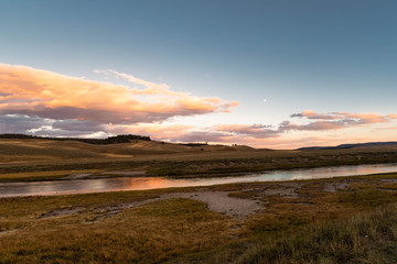 sunset with pink clouds and lake at Yellowstone