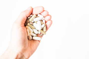 Vitamins in tablets. Pills in the hand. Copy space. White background