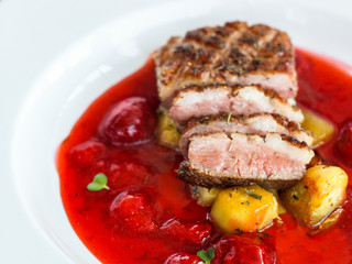 duck breast, vegetables, berry sauce and microgreen (main dish). food background. top view