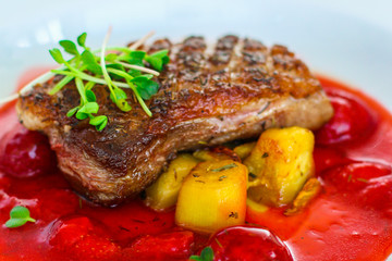duck breast, vegetables, berry sauce and microgreen (main dish). food background. top view