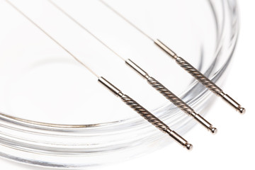 Silver needles for traditional Chinese acupuncture medicine. Isolated white background.