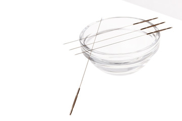 Silver needles for traditional Chinese acupuncture medicine. Isolated white background.
