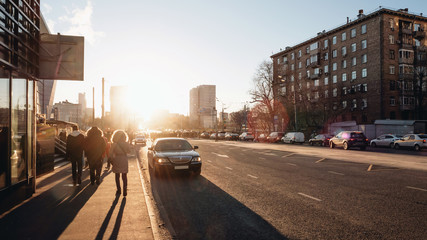 Sunset on the city streets in Moscow at late autumn with a warm light and long shadows