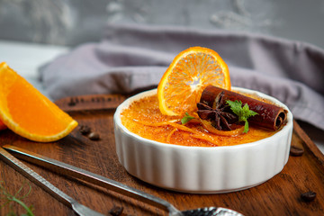 French vanilla Creme brulee dessert in ceramic bowl on wooden board