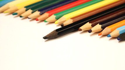 Colored pencils close up in macro photography. Art set of pencils with free space.